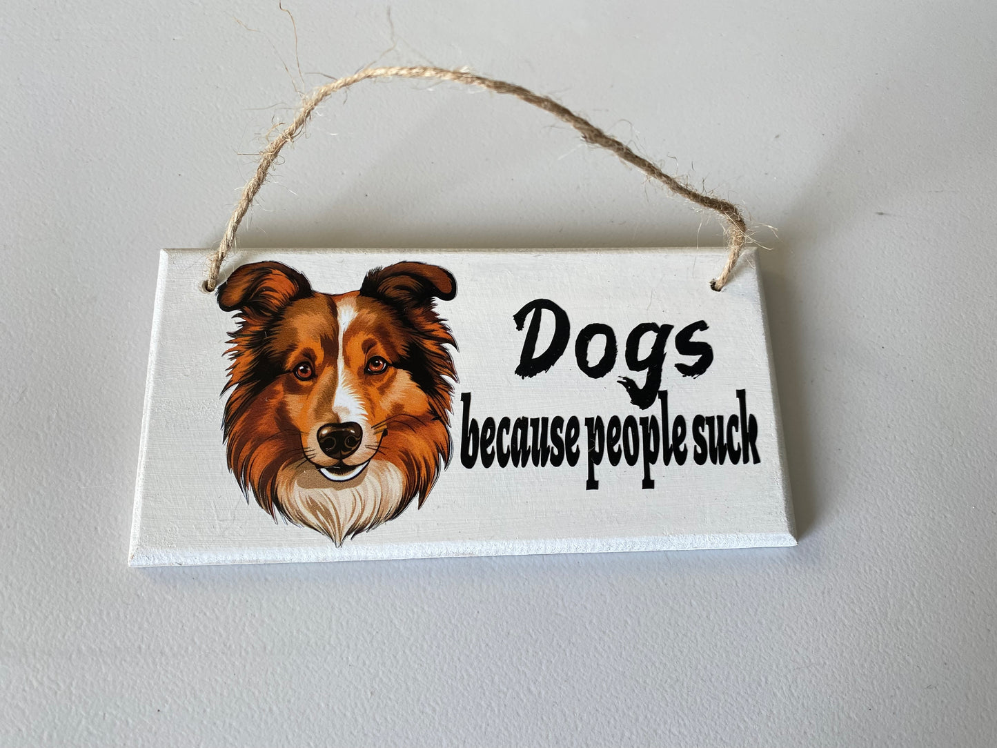 Dog hanging plaque 'people suck'