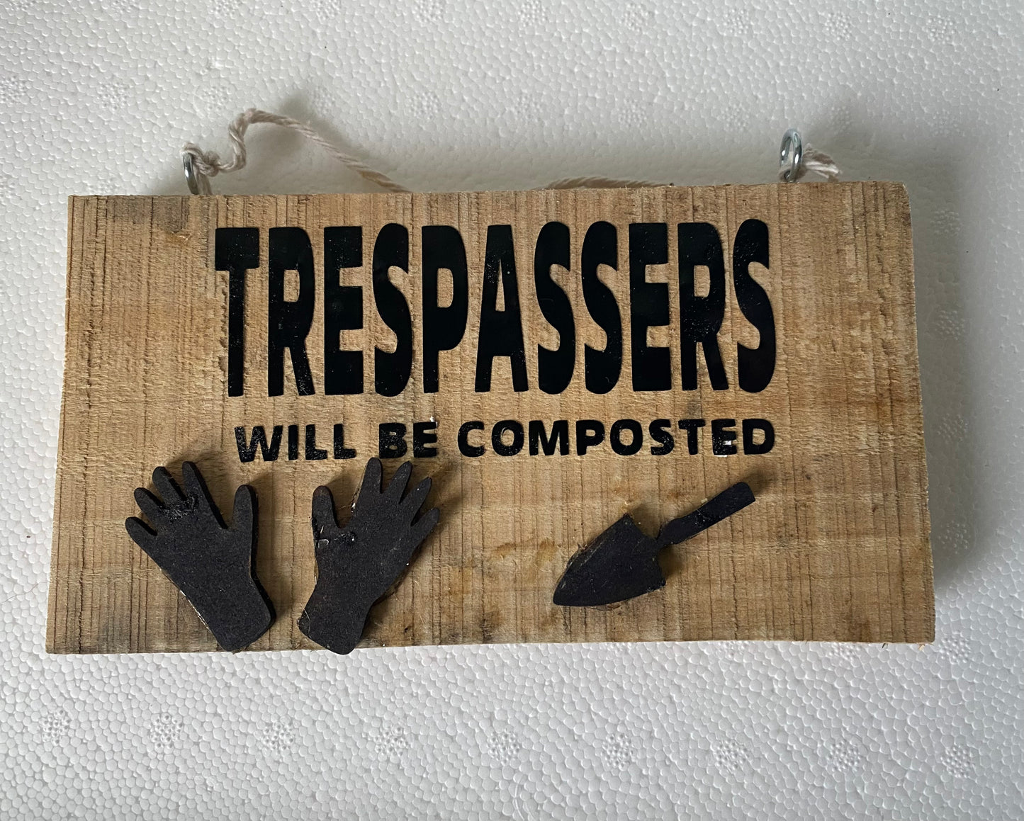 Rustic gardening plaque trespassers