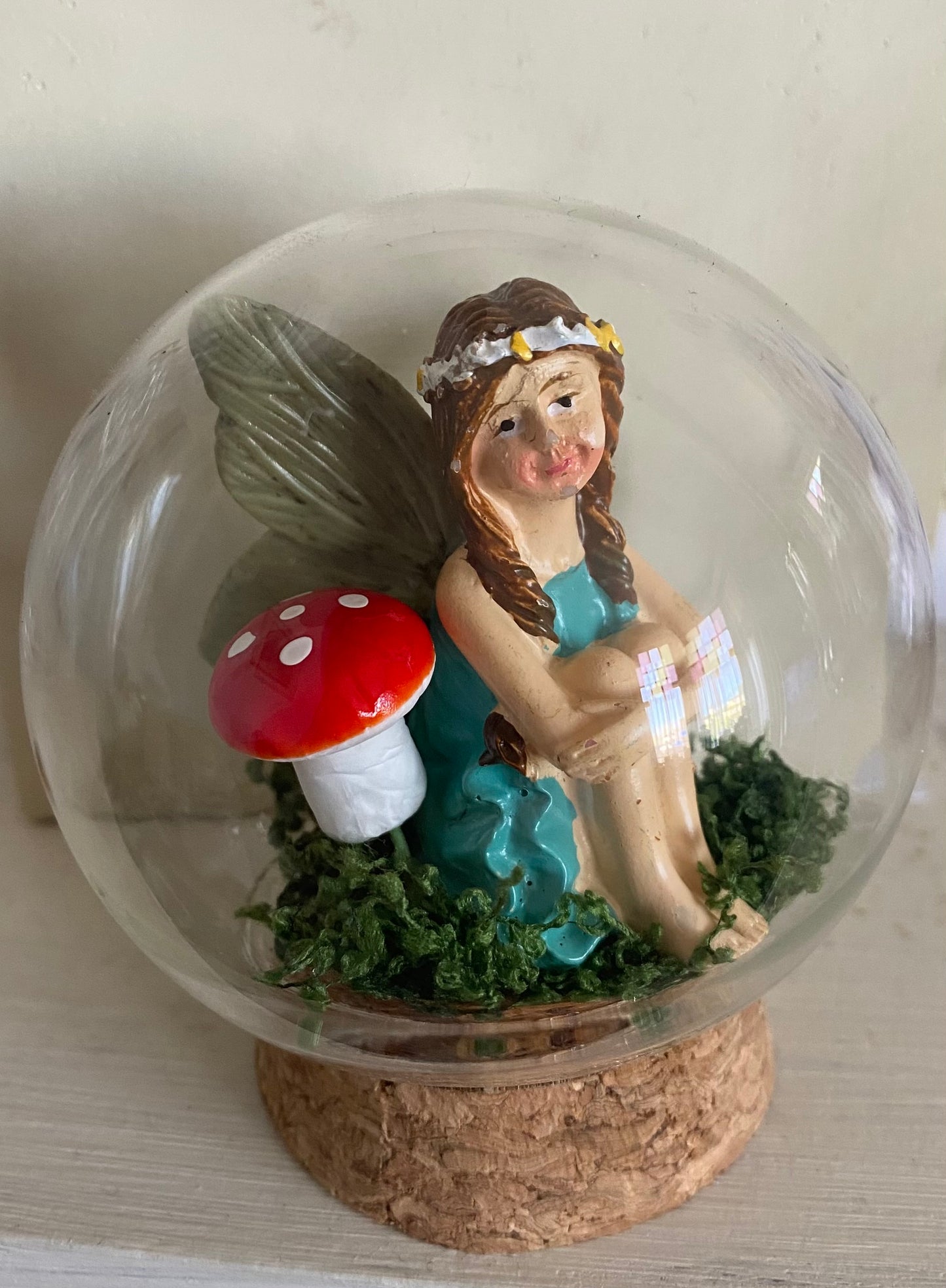 Fairy globe. Sitting fairy blue dress